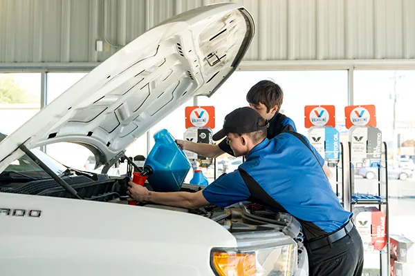 Strickland Brothers Oil Change Technician working on a car.